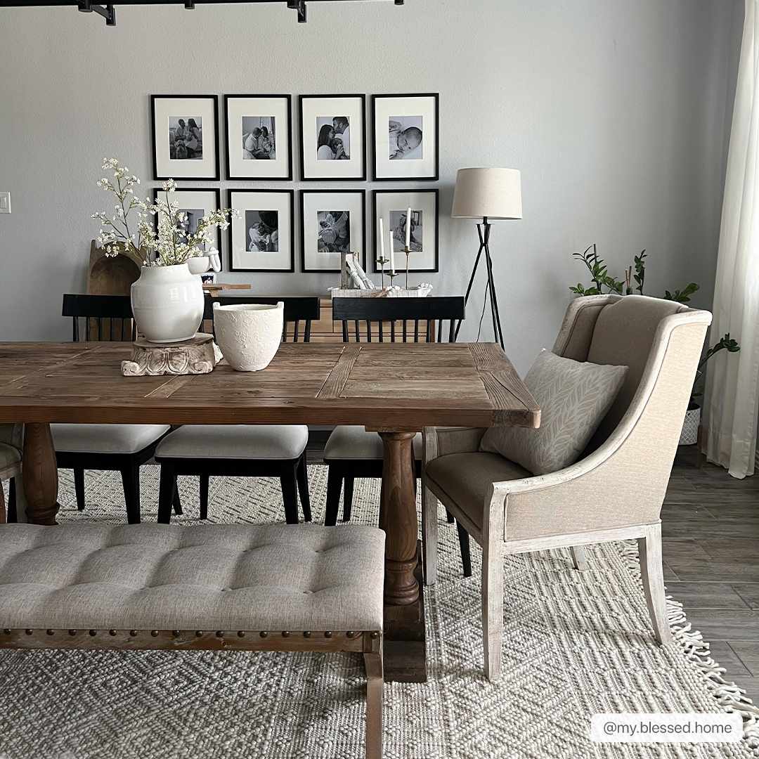 Farmhouse dining room with a wood table, tufted bench, and the Ryne Area Rug in driftwood and white thatch. Roomscene-Rectangle