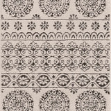 Close-up of the Warroad Area Rug. Charcoal and light beige rug with a traditional, floral-inspired pattern. Design-Runner-2773