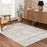 Living room scene with a charcoal and beige Warroad Area Rug, wood floors, and a mid-century modern cabinet. Roomscene-Rectangle