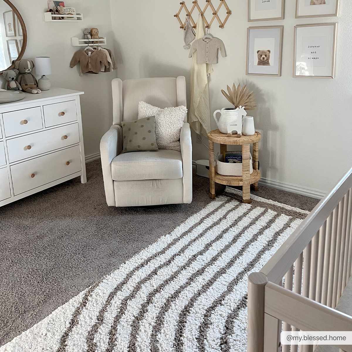 Nursery scene with a white glider chair and striped Jola Beige Area Rug on gray carpet. Roomscene-Rectangle