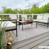 Outdoor patio scene with Beige Charcoal Areli Area Rug, modern furniture, and neutral decor creating a cozy, inviting space. Roomscene-Rectangle