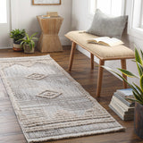 Entryway scene with a beige Calituban Area Rug, wooden bench, plants, and wood accents for a natural, bohemian style. Roomscene-Runner