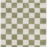 Close-up of the Canika Green Checkered Washable Plush Rug. Green and off-white checkerboard pattern with a plush texture. Design-Runner-2710