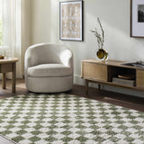 Living room scene with a Canika Green Checkered Washable Plush Rug, neutral chair, wood media console, and light wood floors. Roomscene-Rectangle