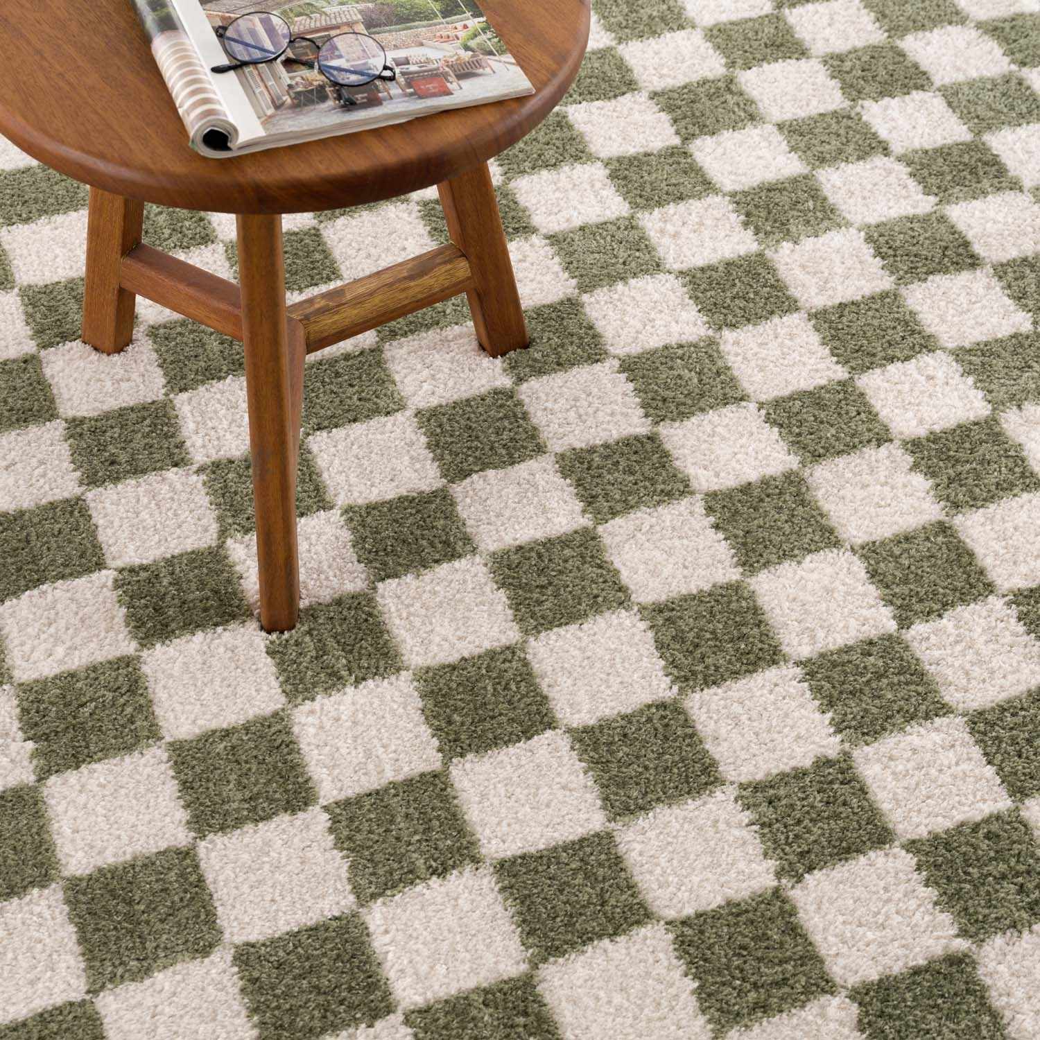 Close-up of Canika Green Checkered Washable Plush Rug. Green and off-white checkerboard pattern with a soft, plush texture. Styleshot