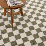 Close-up of Canika Green Checkered Washable Plush Rug. Green and off-white checkerboard pattern with a soft, plush texture. Styleshot