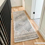 Hallway scene with a geometric Calituban runner rug in gray and beige on light wood floors. Modern farmhouse style. Roomscene-Runner