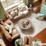 Living room scene with brown leather sofas and a Calituban area rug with a geometric pattern. Roomscene-Rectangle