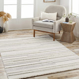 Living room scene with a cream armchair and the cream and light gray striped Dishman Area Rug. Roomscene-Rectangle