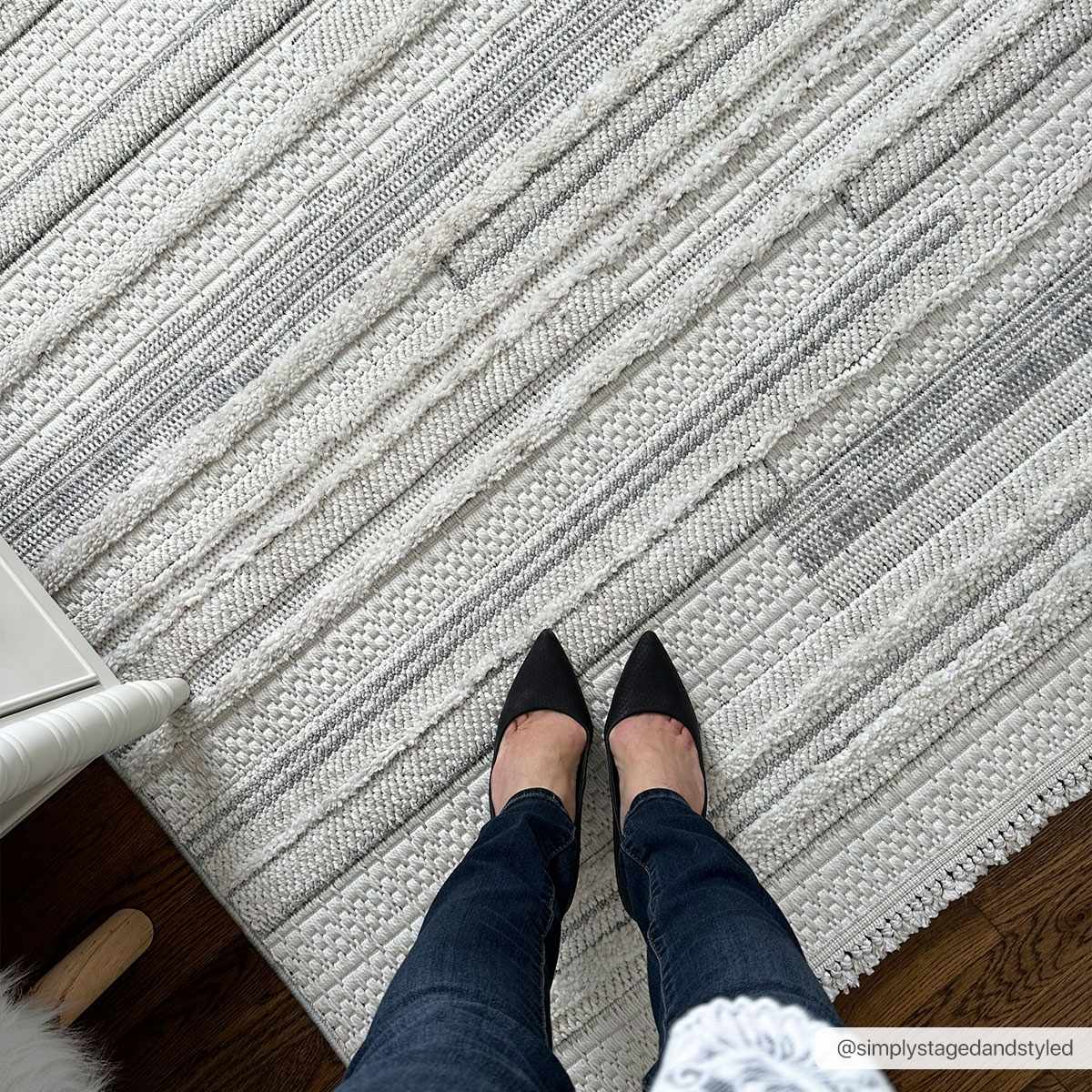 Close-up of the cream and gray striped Dishman Area Rug, showing texture and design detail. Styleshot