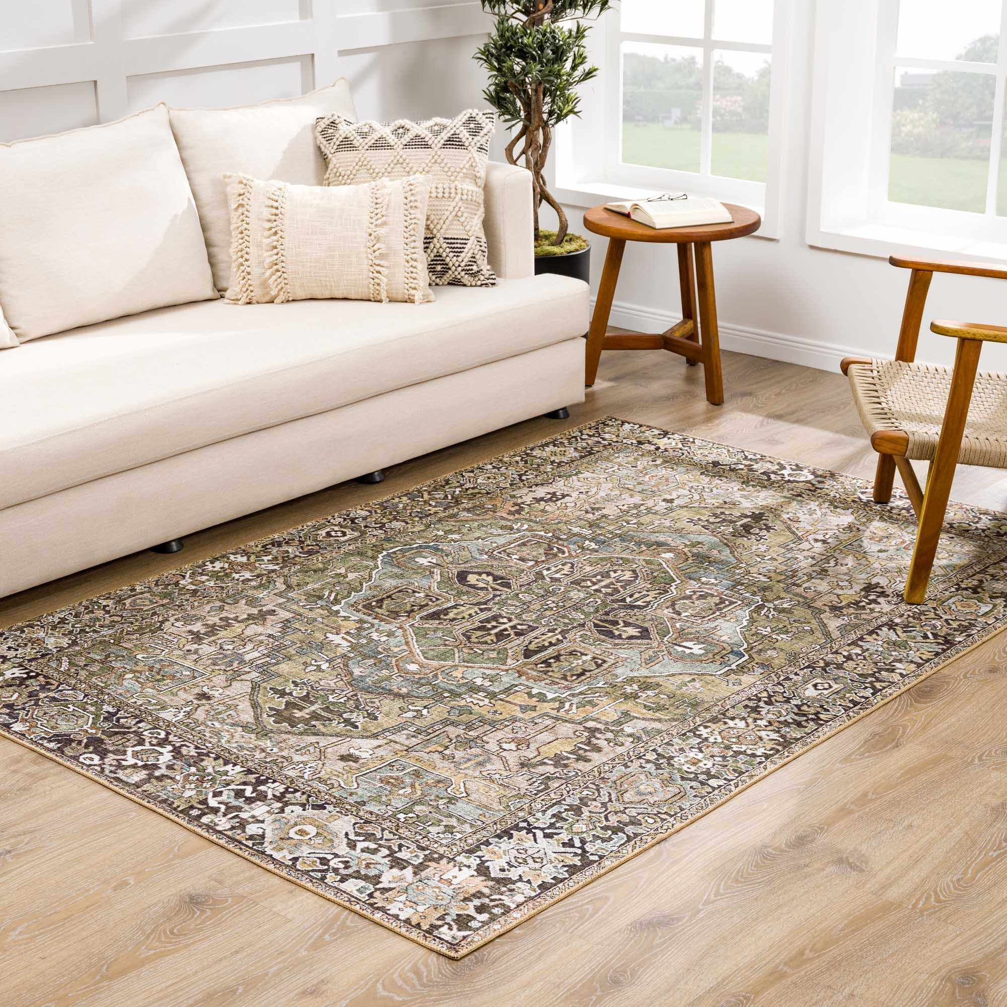 Living room scene with a Neyland Sage Green Area Rug, cream sofa, wood chair, and natural light. Roomscene-Rectangle