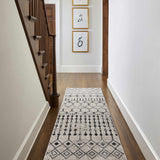Hallway with wood floors and a black and cream Joppatowne Washable Area Rug runner leading to a staircase. Roomscene-Runner
