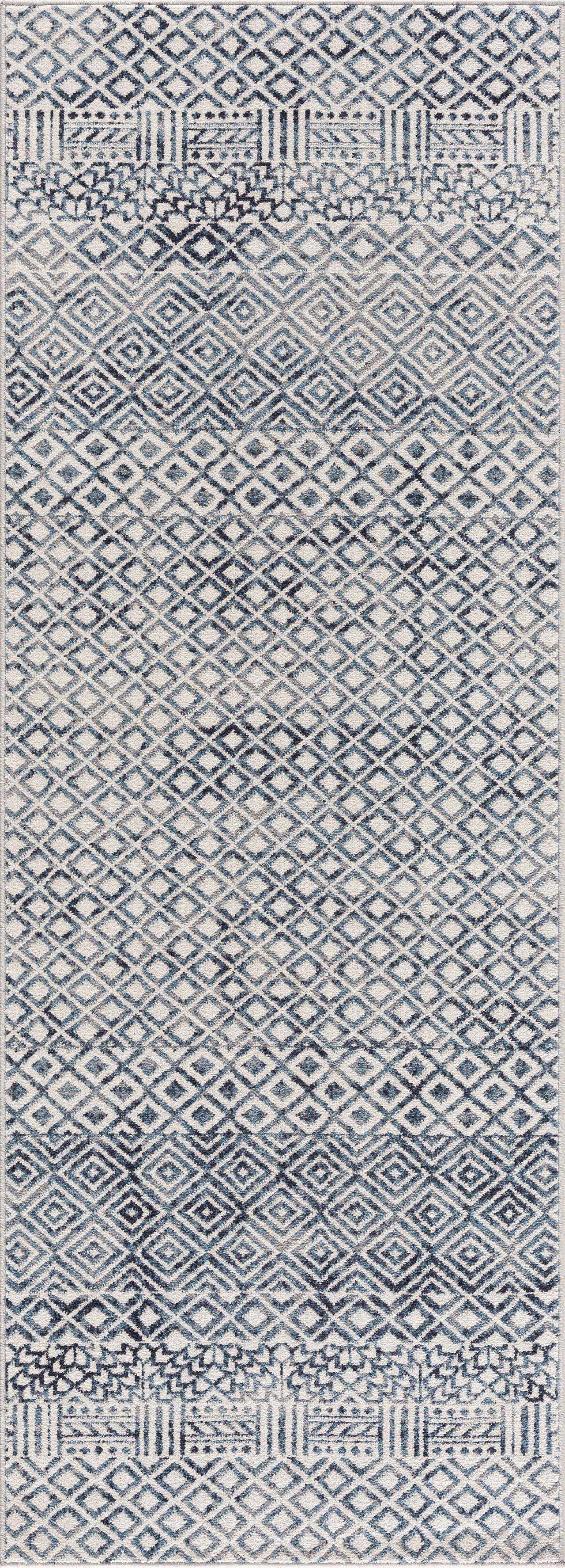 Close-up of the Askeaton Washable Area Rug featuring a blue and gray diamond pattern and tribal-inspired bands. Design-Runner