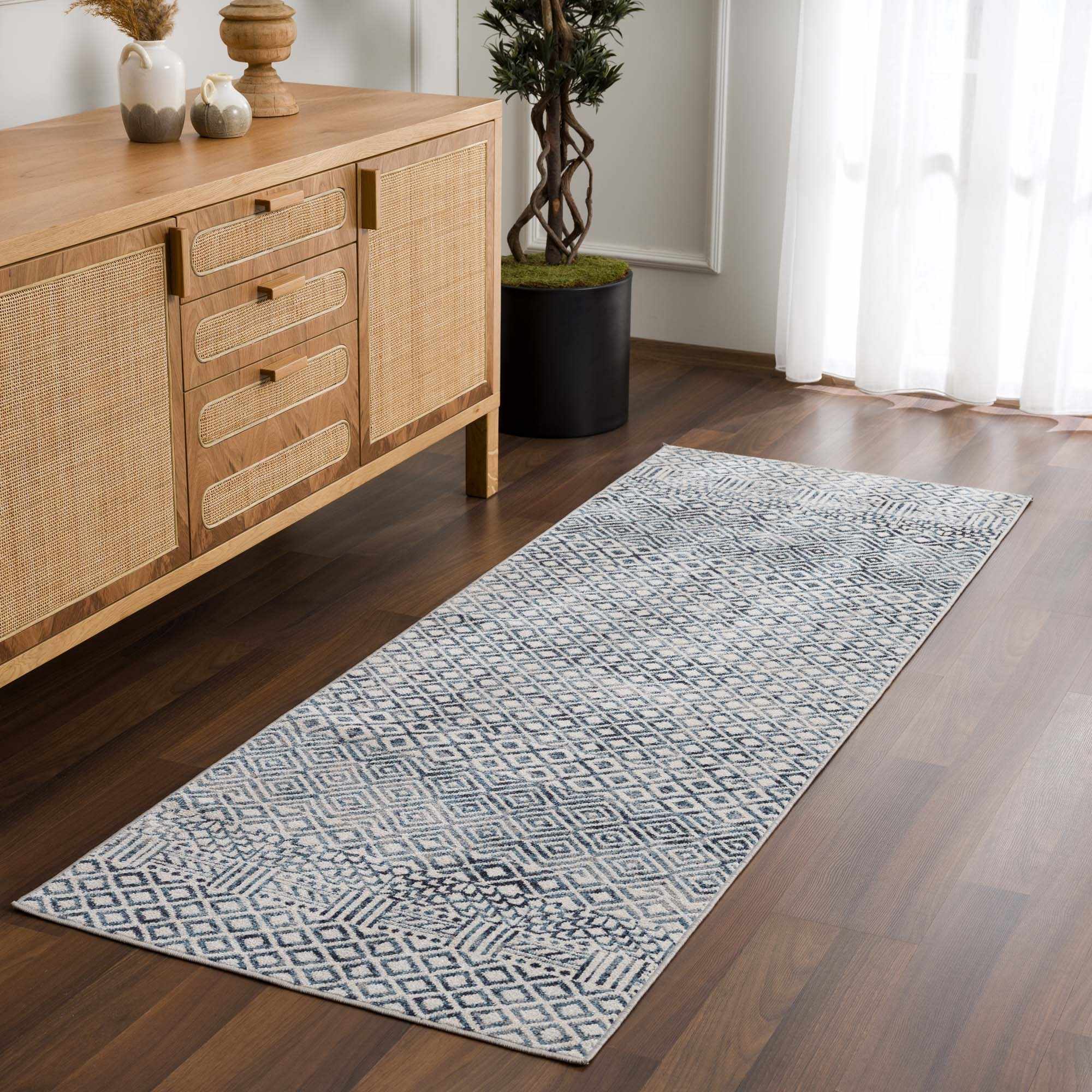 Entryway with wood cabinet and blue geometric Askeaton Washable Area Rug runner on wood floor. Roomscene-Runner