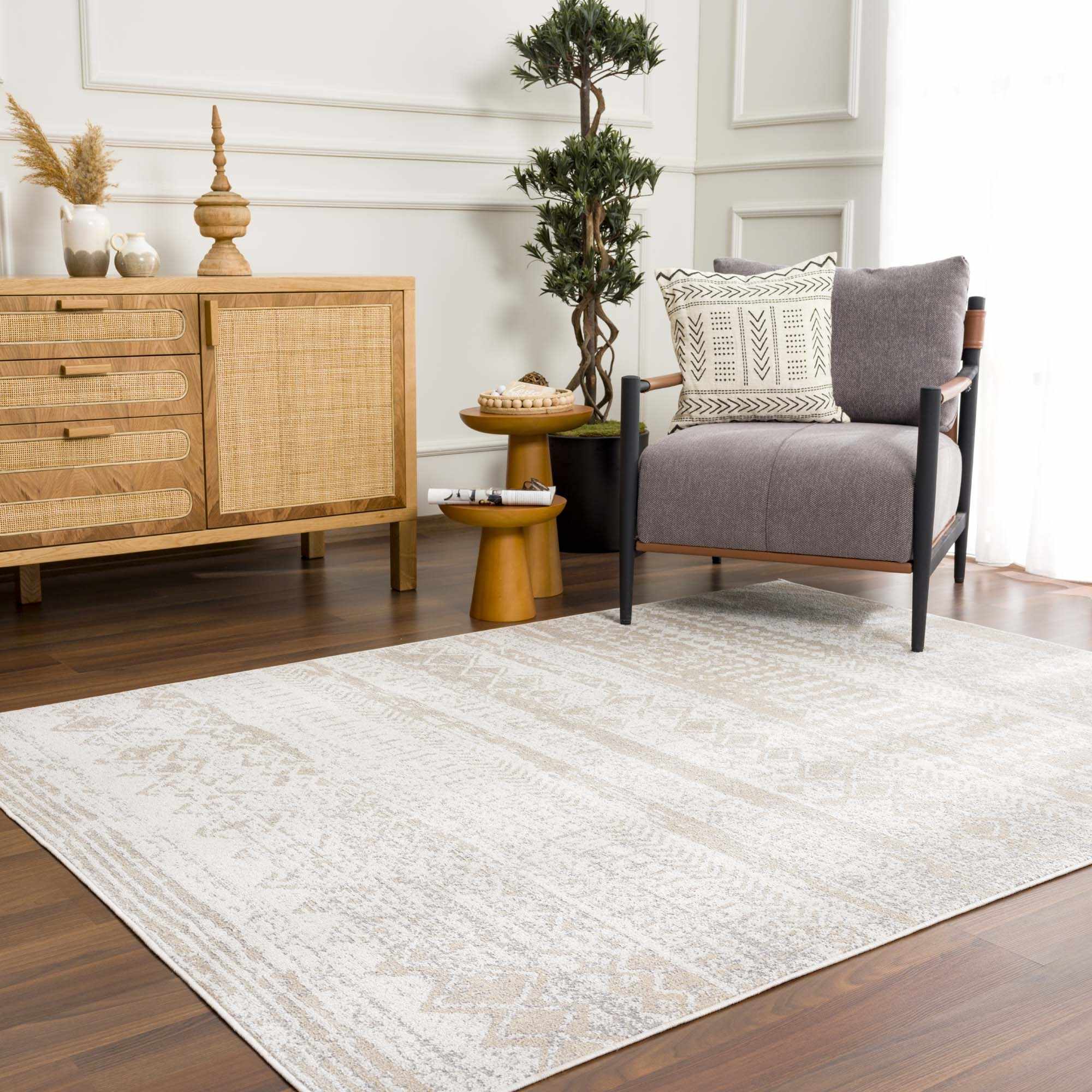 Living room with a cream Tupsan Washable Area Rug, wood cabinet, gray chair, and wood side tables. Roomscene-Rectangle