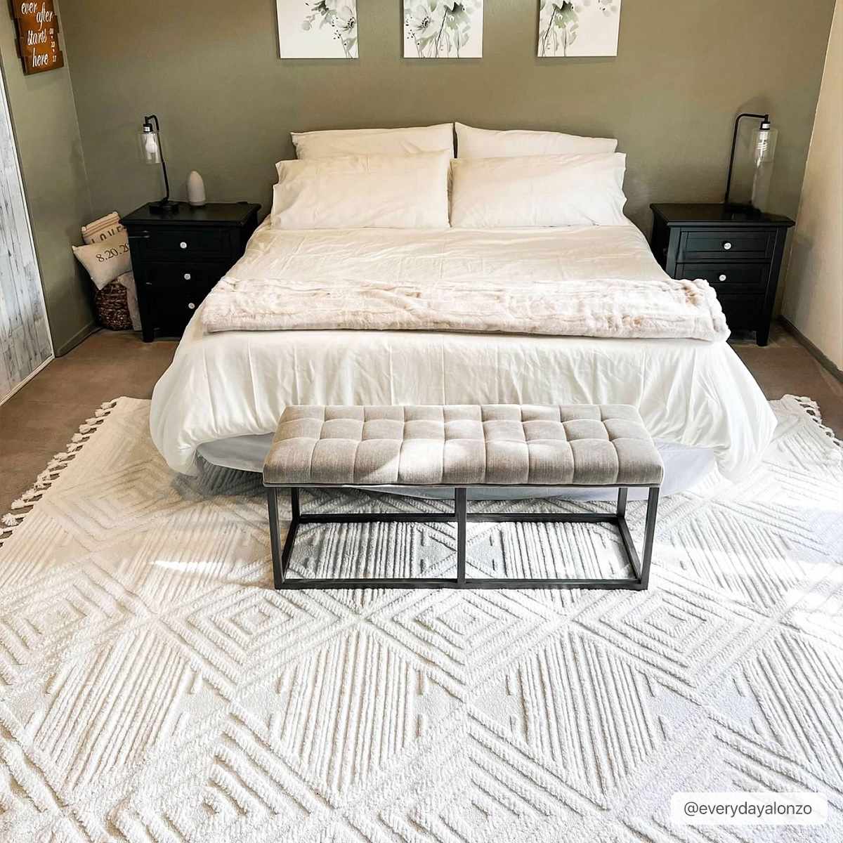 Bedroom scene with a white bed and the Manyas 3D Bone Area Rug with Tassels, showcasing its geometric pattern and tassels. Roomscene-Rectangle
