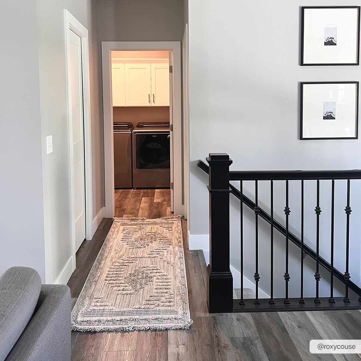 Hallway scene with a cream Muricay High-Low Rustic Rug leading to a laundry room with gray wood floors. Roomscene-Runner