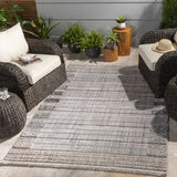 Outdoor patio scene with wicker furniture and the Naivasha area rug in charcoal, cream, and beige. Roomscene-Rectangle