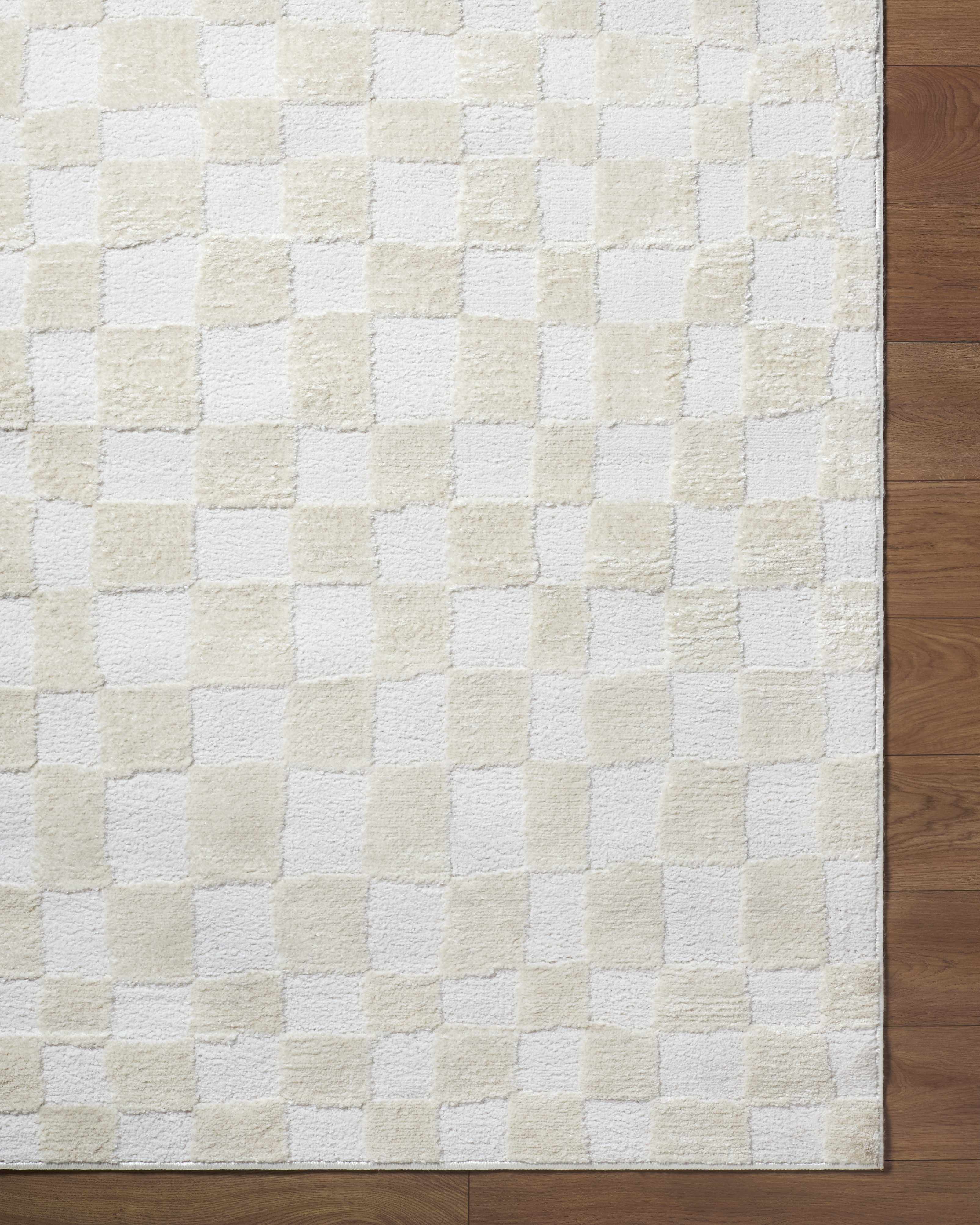 Close-up of the Keesa Checkered Area Rug. Ivory and off-white checkerboard pattern with a plush, textured pile. Corner
