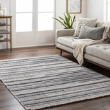 Living room scene with a gray sofa and the striped gray Silanga Area Rug on dark wood floors. Roomscene-Rectangle
