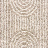 Close-up of the Emmly Shag Area Rug. Shag rug with a geometric pattern in white thatch, light peach, and nutmeg hues. Design-Rectangle-5373