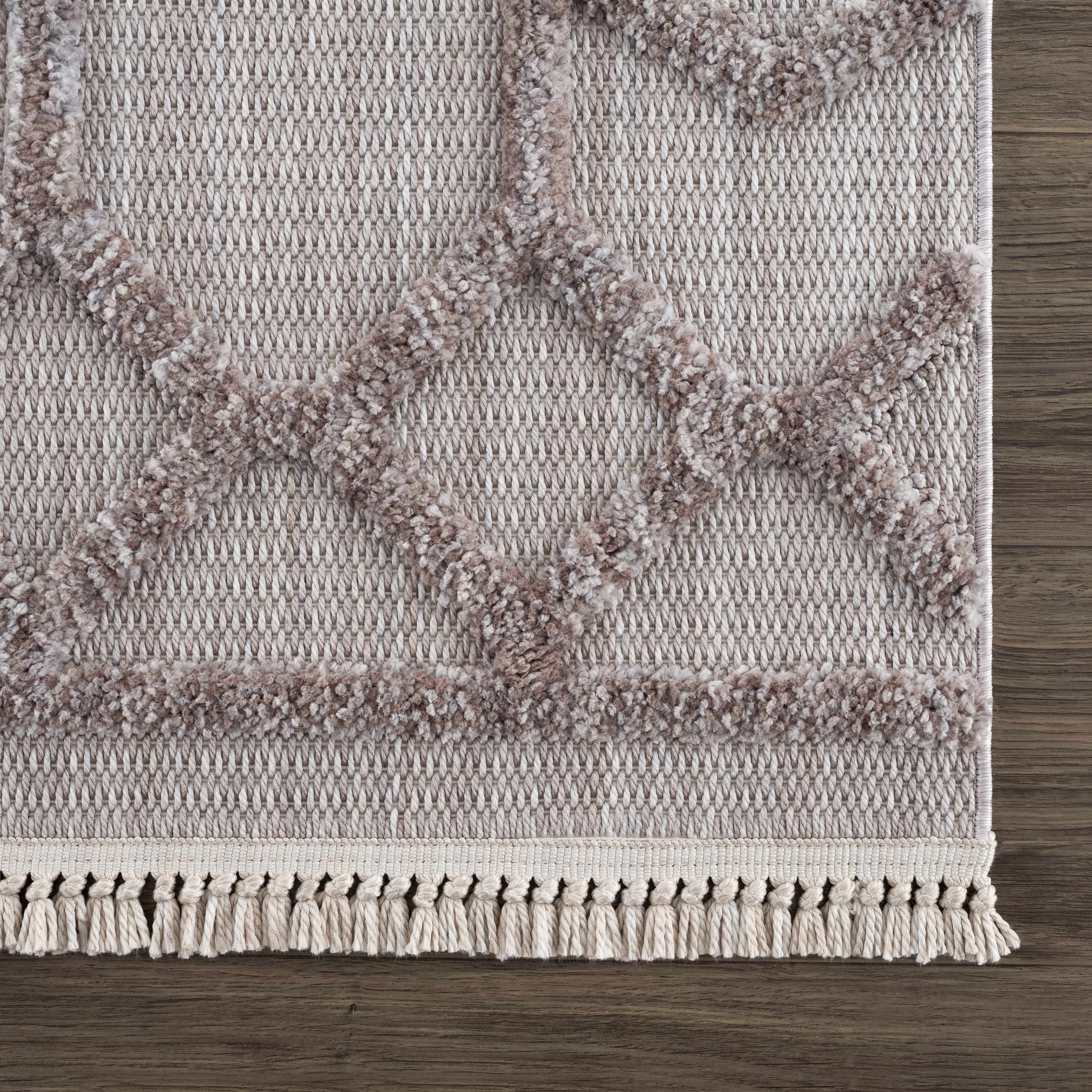 Close-up of the Borbon Area Rug. Cream and gray geometric design with a textured, high-pile pattern and knotted fringe. Swatch