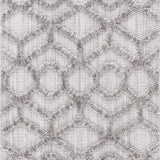 Close-up of the Borbon Area Rug, a machine-woven rug with a geometric gray and cream diamond and circle pattern. Design-Runner-2773