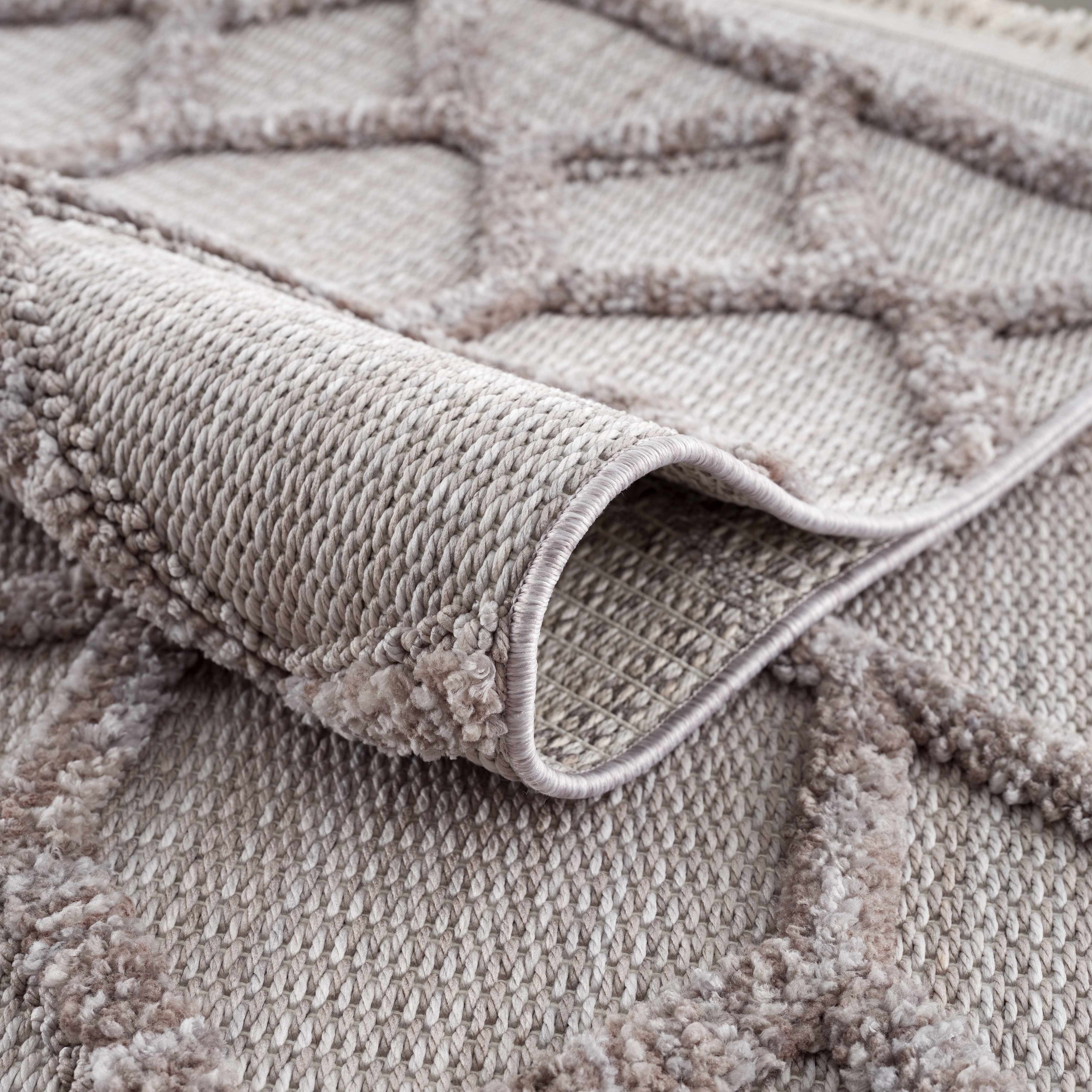 Close-up of the gray Borbon Area Rug showing geometric pattern and woven texture. Fold