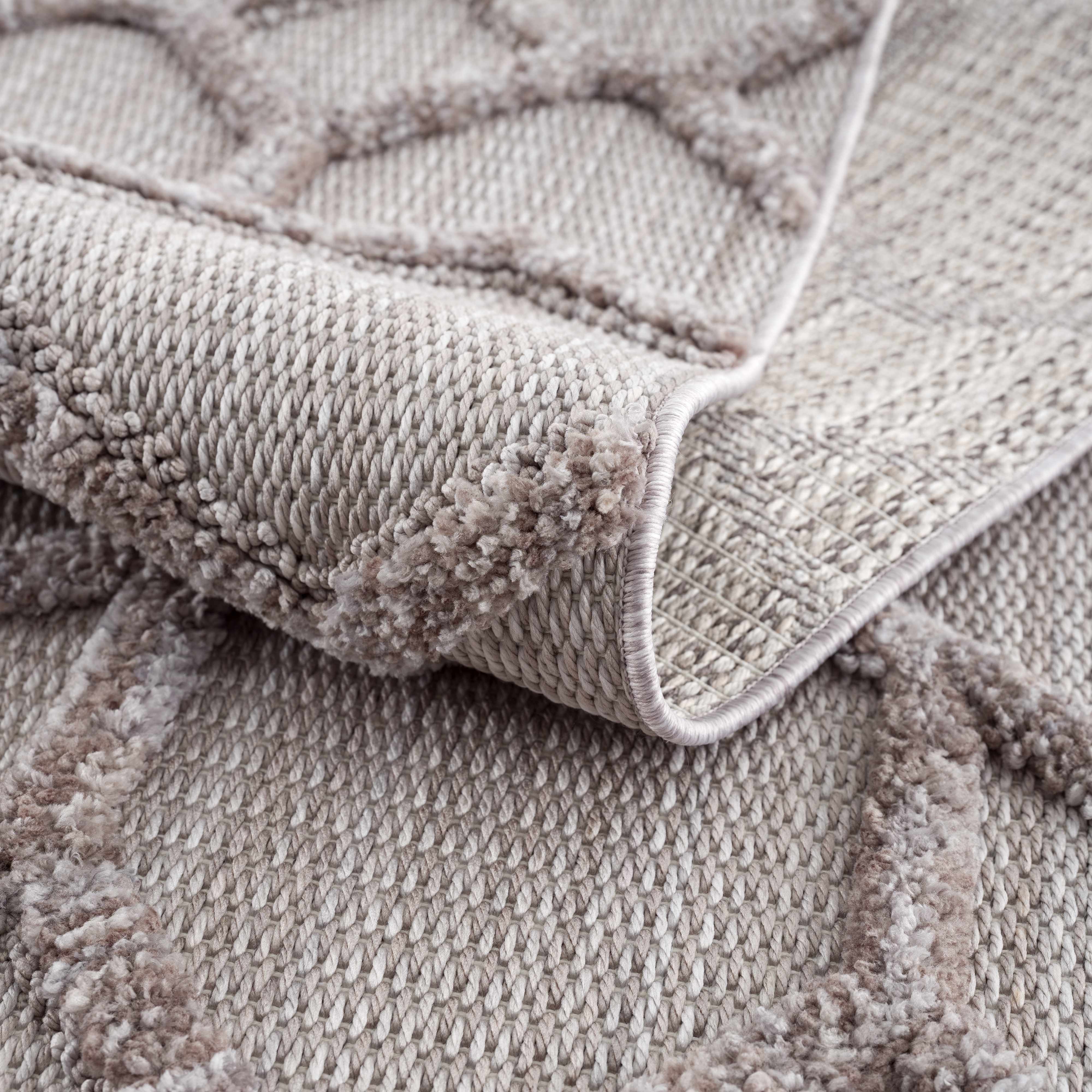 Close-up of the cream and gray Borbon Area Rug showing geometric pattern and woven texture. Fold