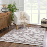 Living room scene with a cream Borbon Area Rug, white chair, wood cabinet, and large window. Roomscene-Rectangle