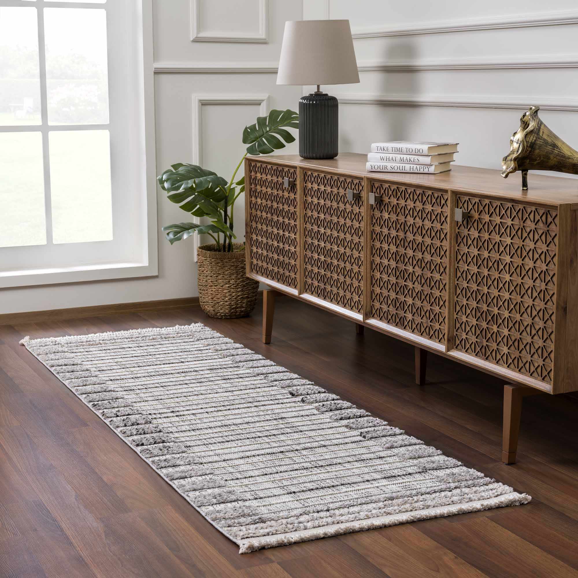Hallway scene with a Naivasha Elegant High/Low Area Rug in charcoal, cream, and gray, styled with a wood console table. Roomscene-Runner