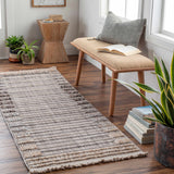 Entryway with Naivasha Elegant rug in charcoal and cream, wood bench, plants, and books for a cozy, Scandinavian feel. Roomscene-Rectangle