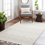 Living room scene with a neutral Ryne Area Rug, gray chair, and wood accents for a cozy, transitional style. Roomscene-Rectangle