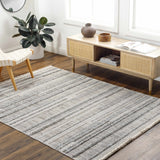 Living room scene with light wood floors, Silanga Area Rug, woven chair, and mid-century modern console table. Roomscene-Rectangle