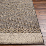 Close-up of Beige Charcoal Areli Area Rug showing geometric pattern and textured weave on wood floor. Front