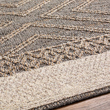 Close-up of the Beige Charcoal Areli Area Rug, showcasing its geometric pattern and textured weave. Texture