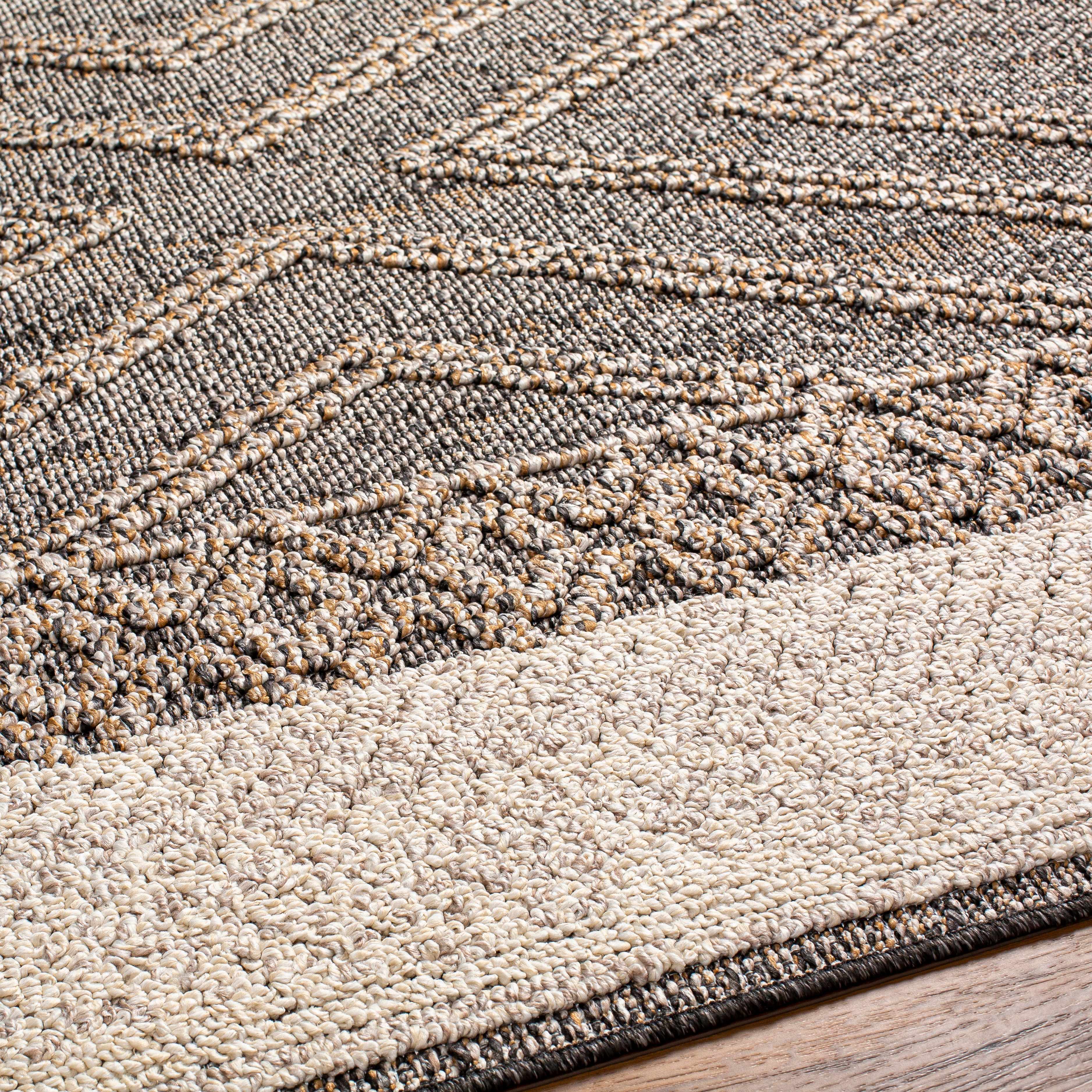 Close-up of the Beige Charcoal Areli Area Rug, showcasing its geometric pattern and textured weave. Texture