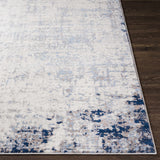 Close-up of the Texanna Abstract Blue/Gray Area Rug showing its contemporary design, colors, and soft texture. Front