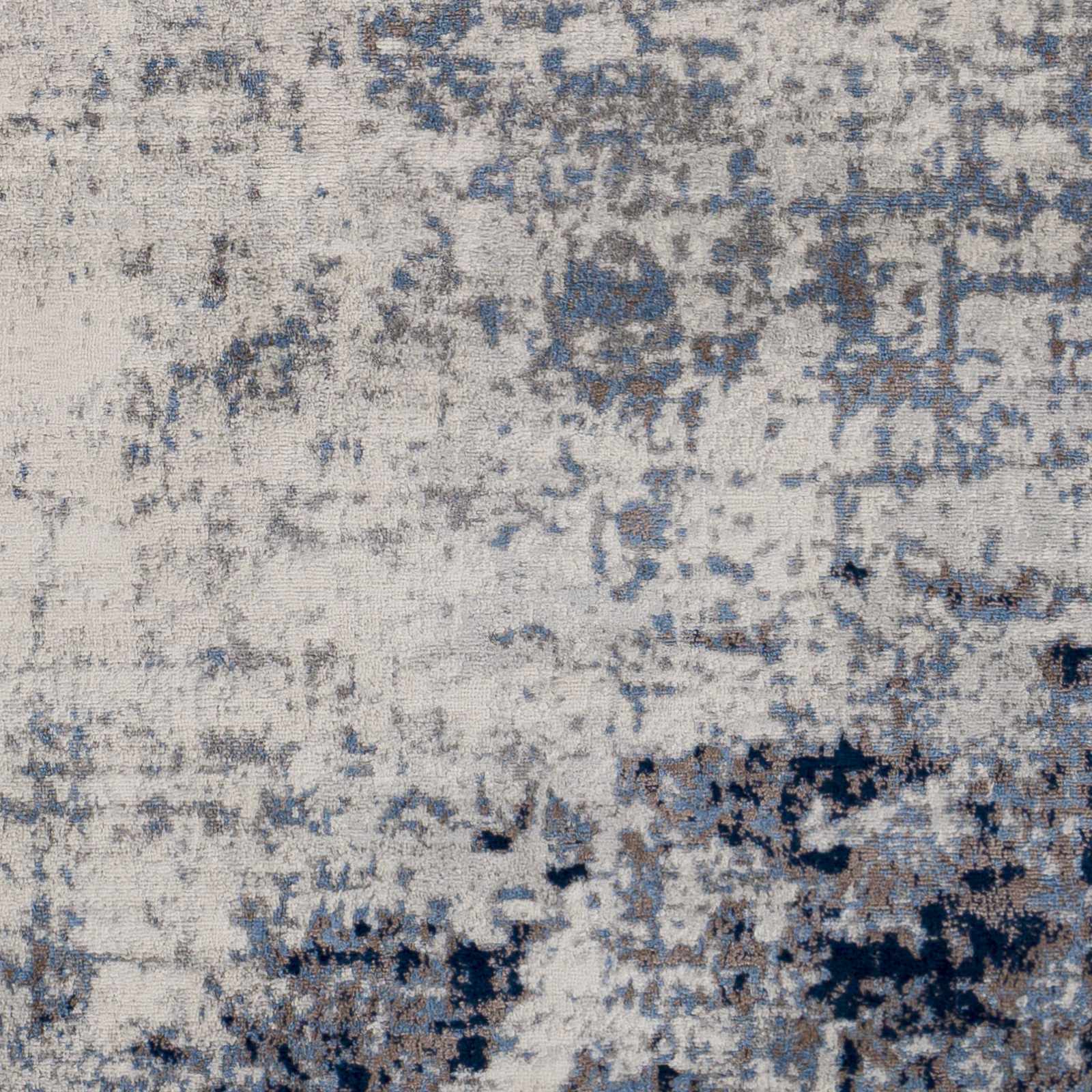 Close-up of the Texanna Abstract Blue/Gray Area Rug showing its soft texture and contemporary blue, gray, and off-white pattern. Swatch