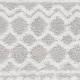 Close-up of the Vernonburg Shag Area Rug, showcasing its light gray and white geometric pattern and soft, shaggy texture. Swatch